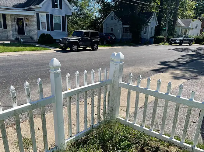 white picket fence covered with dirt and grime